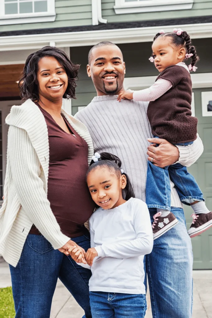 happy family in front of house